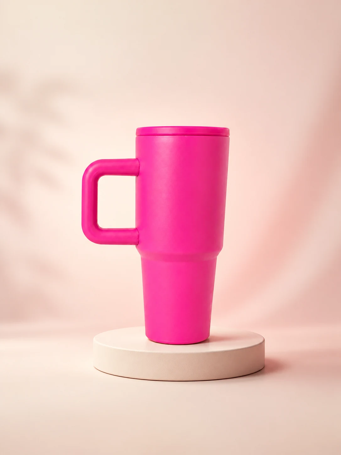KIVO 20 handled tumbler in Bloom pink on a minimal stage